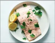  ?? (The New York Times/David Malosh) ?? This perfectly seasoned salmon cooks quickly in the microwave and can be enjoyed on its own or used in salads, grain bowls or other dishes.