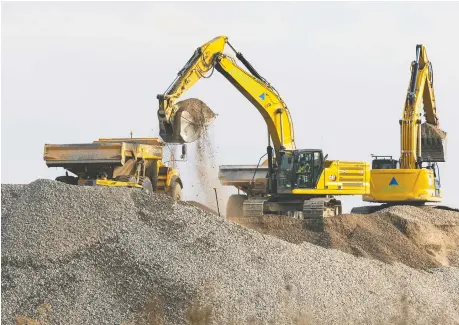  ?? MIKE HENSEN FILES ?? Dump trucks move fill as they ready the site of the $7-billion Volkswagen battery gigaplant in St.thomas, Ont.