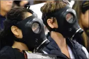  ??  ?? Protestors wearing gas masks attend a Jan. 16 hearing about a gas leak at the Southern California Gas Co.’s Aliso Canyon Storage Facility near Porter Ranch. Thousands of residents have been driven from their homes.
