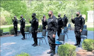  ?? COURTESY WORCESTER COUNTY SHERIFF'S DEPARTMENT ?? The recruits of WCSO Basic Recruit Training Academy No. 53, including Officer Michael Fleming of Fitchburg, below, take their official oath to become correction­al officers during a small, private and masked ceremony held on the grounds of the Sheriff's Department in late May.