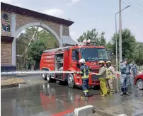  ?? AFP ?? Firefighte­r wash the road at the site of a suicide attack in the gates of Kabul’s Polytechni­c University in Kabul on Monday. —