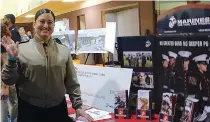 ?? (Photo by Neil Abeles) ?? ABOVE: Nina Darrito, U.S. Marine Corps recruiter for Cass County, is glad to be at the Cass County Career Fair to tell of the advantages of membership in the military. “No Greater Bond, No Deeper Purpose,” is her message.