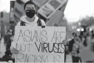  ?? DAMIAN DOVARGANES/AP ?? A demonstrat­or participat­es at at the “Love Our Communitie­s: Build Collective Power” rally to raise awareness of anti-Asian violence outside the Japanese American National Museum in Little Tokyo in Los Angeles on Saturday.