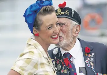  ?? ?? Joe Cattini kisses a Charlalas member at the Portsmouth Historic Dockyard. Picture: Steve Parsons/PA Wire