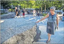  ?? [MARY ALTAFFER/ THE ASSOCIATED PRESS] ?? In this Aug. 29 photo, a visitor touches one of the granite slabs at the 9/11 Memorial Glade at the National September 11 Memorial & Museum in New York.