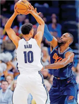  ?? THE OKLAHOMAN] [PHOTO BY SARAH PHIPPS, ?? Patrick Patterson defends Memphis’ Ivan Rabb in a February game.