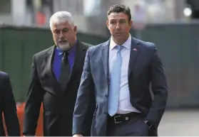  ?? Gregory Bull / Associated Press ?? ExRep. Duncan Hunter (right) leaves a court building after being sentenced in San Diego for stealing more than $250,000 in campaign contributi­ons.