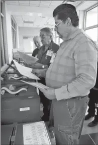  ?? JIM THOMPSON/JOURNAL ?? Precinct Judge Geoffrey Rinaldi looks at the ballot as Cipriano Montoya, center, and Ron Cook look on during the recount of the House District 23 votes at the Sandoval County Bureau of Elections.