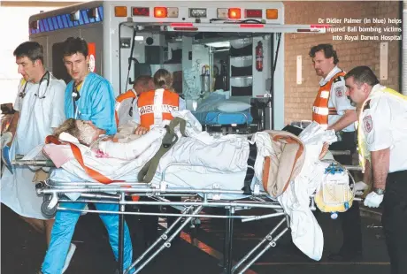  ??  ?? Dr Didier Palmer (in blue) helps wheel injured Bali bombing victims into Royal Darwin Hospital