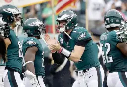  ?? AP Photo/ Matt Rourke, File ?? Philadelph­ia Eagles' Carson Wentz cheers on his team before an NFL football game against the Arizona Cardinals Oct. 8 in Philadelph­ia. The Eagles face the Carolina Panthers in a showdown tonight.