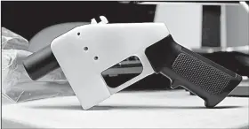  ?? AP/ERIC GAY ?? A 3-D-printed gun sits on display Wednesday at Defense Distribute­d in Austin, Texas. A temporary restrainin­g order issued Tuesday in Seattle stopped the company from posting blueprints for the gun online.