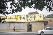  ?? ADRIA MALCOLM / THE NEW YORK TIMES ?? Spanish on the side of the building at Chavez Karate in the South Valley of Albuquerqu­e, N.M. The U.S. is emerging as a vast laboratory showcasing the remarkable endurance of Spanish.