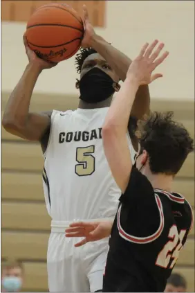  ?? PHOTOS BY KEN SWART — FOR MEDIANEWS GROUP ?? Stoney Creek’s Trevor Smith Jr. (5) shoots for two of his game-high 21points over Troy’s Ethan Emerzian during the D1district final played on Saturday at Stoney Creek HS. The Cougars defeated the Colts 42-36 to win the title.