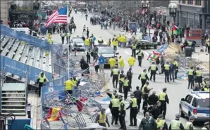  ??  ?? NEAR THE SITE: Bloomberg photograph­er Kelvin Ma was stationed about 15m from the finish line at the Boston Marathon.