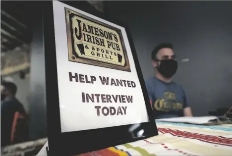  ?? AP PHOTO/MARCIO JOSE SANCHEZ ?? A hiring sign is placed at a booth for Jameson’s Irish Pub during a job fair on wood section of Los Angeles.
Sept. 22 in the West Holly