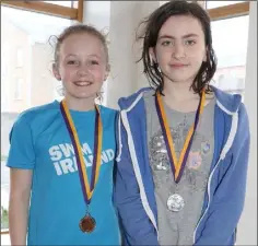  ??  ?? Eva Bailey (Bree/Davidstown, gold medal winner), and Cáit O’Carroll (Castlebrid­ge/Crossabeg, silver medal winner) after the girls’ Under-12 backstroke final.