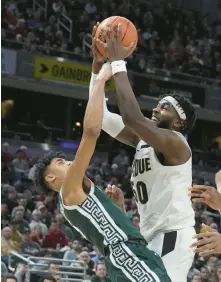  ?? DARRON CUMMINGS/AP ?? Purdue forward Trevion Williams (50) grabs a rebound against Michigan State guard Max Christie (5) during the first half of their semifinal game.