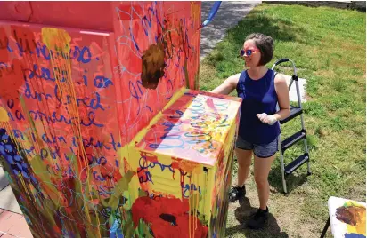  ?? ARKANSAS DEMOCRAT-GAZETTE FILE PHOTOS ?? Artist Tiffany Hamlin paints a utility box at the Seventh and Main streets in North Little Rock. The project is part of the Argenta Arts District’s mural project.