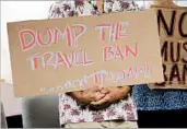  ?? CALEB JONES/AP ?? Critics of President Donald Trump's travel ban show their opposition during a summer news conference in Honolulu.