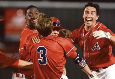  ?? Jerry Baker photos / For the Chronicle ?? Atascocita’s Hunter Hall (3) is mobbed by his teammates, including Dawud Shorts, from left, Kyle Brann, and Matt Willrodt after Hall drove in Willrodt with the winning run against Kingwood in the bottom of the 7th inning of their District 16-6A match-up last week.