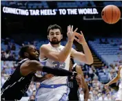  ?? AP PHOTO BY GERRY BROOME ?? North Carolina’s Luke Maye (32) loses the ball while Mount Olive’s Cameron Robinson defends during the first half of a college basketball exhibition game in Chapel Hill, N.C., Friday, Nov. 2.