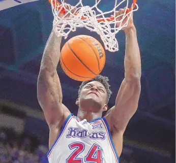  ?? CHARLIE RIEDEL/STAFF, ASSOCIATED PRESS ?? Kansas forward K.J. Adams Jr. dunks the ball during the first half of an NCAA college basketball game against UConn on Friday in Lawrence, Kan.