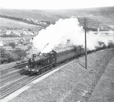  ?? S Rickard/J & J Collection ?? On the same day, Treherbert shed turn TD was in the hands of ‘5600’ class 0-6-2T No 5688 seen approachin­g Llwynypia, climbing the 1 in 165 gradient, with the 3.45pm Barry Island to Treherbert stopping passenger train. These workings could be quite challengin­g to locomotive crews, especially the fireman, as there were 22 stops on the route.