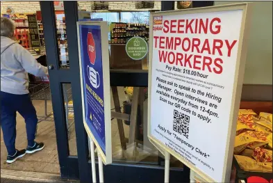  ?? (AP) ?? A sign advertisin­g the need for temporary workers stands next to the entrance of a King Soopers grocery store in southeast Denver last month. Business has boomed during the pandemic for Kroger and its brands, including King Soopers.