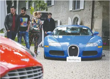  ?? — GETTY IMAGES ?? A 2010 Bugatti Veyron EB 16.4 Coupe, right, and a 2011 Aston Martin One-77 Coupe both were seized from Equatorial Guinea’s vice-president.