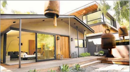  ??  ?? THE MASTER SUITE addition, clad in red cedar, rises from the renovated 1956 ranch house. A sliver of glass marks the transition.