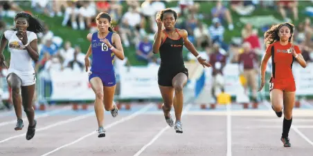  ?? Michael Macor / The Chronicle 2010 ?? Ashton Purvis (in black) of St. Elizabeth in Oakland sprints to the finish to win the girls’ 100meter dash at the 2010 CIF Finals.