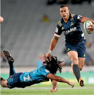  ?? PHOTO: GETTY IMAGES ?? Highlander­s wing Tevita Li leaves a Blues defender grasping at air during their Super Rugby match at Eden Park in Auckland last night.