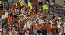  ?? (AP file photo) ?? Texas fans sing “The Eyes of Texas” after the Longhorns defeated UTEP 59-3 in a college football game in September. A university report on the song released Tuesday found it had “no racist intent.”