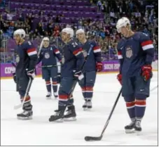  ??  ?? Team USA players skate off the ice following Saturday’s loss to Finland.