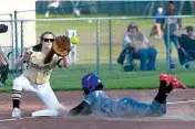  ?? Staff photo by Jerry Habraken ?? Pleasant Grove’s Presley Hargrove reaches out for the ball as Liberty-Eylau’s M.J. Coleman dives to third base Tuesday at Lady Hawk Field in Texarkana, Texas.