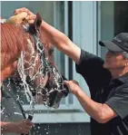  ?? ASSOCIATED PRESS ?? Triple Crown hopeful Justify is bathed by Carlos Martin after a workout Friday in preparatio­n for the Belmont Stakes.