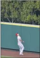  ??  ?? The Angels’ Mike Trout watches a home run hit by the Rangers’ Adolis Garcia clear the fence during Wednesday’s loss at Angel Stadium.