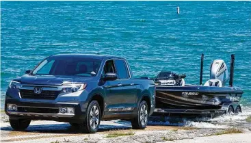  ?? Honda photo ?? Rated to tow up to 5,000 pounds, the all-wheel-drive Ridgeline’s traction management system offers normal, snow, mud and sand modes.