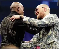  ?? AP/ISAAC BREKKEN ?? Floyd Mayweather Jr. (left) and Conor McGregor embrace during a news conference after their much-ballyhooed meeting Saturday in Las Vegas. Mayweather won by TKO in the 10th round.