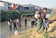  ??  ?? 60 per cent of water supplies at the Kutupalong refugee camp, above, are contaminat­ed