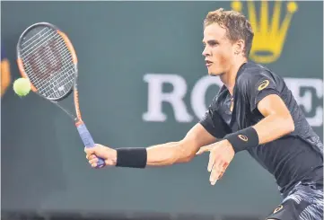  ?? — USA TODAY Sports photo ?? Vasek Pospisil hits a ball as he defeated Andy Murray in his second round match in BNP Paribas Open at the Indian Wells Tennis Garden.