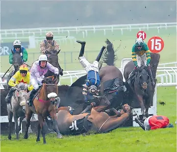  ??  ?? All fall down: Horses and jockeys escaped unscathed from this pile-up during the BetVictor Handicap Chase yesterday