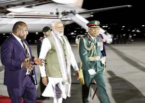  ?? PHOTO: PAPUA NEW GUINEA GOVERNMENT/HANDOUT VIA REUTERS ?? Pacific ties . . . India’s Prime Minister Narendra Modi (centre) is greeted by Papua New Guinea’s Prime Minister James Marape (left) at Jackson Internatio­nal Airport, in Papua New Guinea on Sunday.