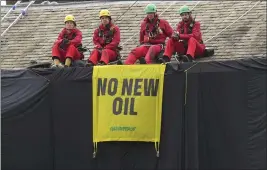  ?? DANNY LAWSON — PA VIA AP ?? Greenpeace activists sit on the roof of Britain's Prime Minister Rishi Sunak's house in Richmond, North Yorkshire, England, after covering it in black fabric Thursday.