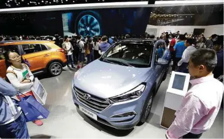  ?? BLOOMBERG PIC ?? Visitors looking at the new Hyundai Tucson at the Auto China show last year. Hyundai and Kia have seen their combined China sales slump by 52 per cent last month from a year earlier.