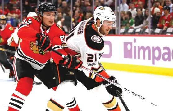  ??  ?? Defenseman Gustav Forsling ( tangling with the Ducks’ Chris Wagner) has grown into the role the Hawks envisioned for him in his second season. | GETTY IMAGES
