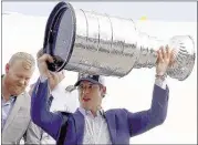  ?? KEITH SRAKOCIC/ASSOCIATED PRESS ?? Pittsburgh star Sidney Crosby (right, with Patric Hornqvist) hoists the Stanley Cup after the team’s flight arrived at Greater Pittsburgh Internatio­nal Airport in Moon, Pa., on Monday, a day after the Penguins won their fourth title.
