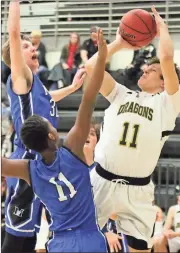  ?? Jeremy Stewart / RN-T ?? Pepperell’s Davis McGinty (11) tries to take a shot against Model’s Justin Roberts (left) and Josh Smith during the second half of Friday’s Region 7-AA game at Pepperell High School. Model won 60-39.