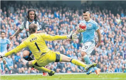  ??  ?? Sergio Aguero, right, scores the third goal for Manchester City.