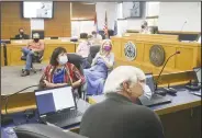  ?? (NWA Democrat-Gazette/Charlie Kaijo) ?? Justices of the Peace (from foreground) Kurt Moore, Debra Hobbs, Carrie Perrien Smith, Kenny Bierman and Joel Edwards (left) pay attention to a presentati­on Thursday at the Benton County Administra­tion Building in Bentonvill­e. The Quorum Court held its first meeting in the newly expanded Quorum Courtroom. Go to nwaonline.com/200925Dail­y/ for today’s photo gallery.